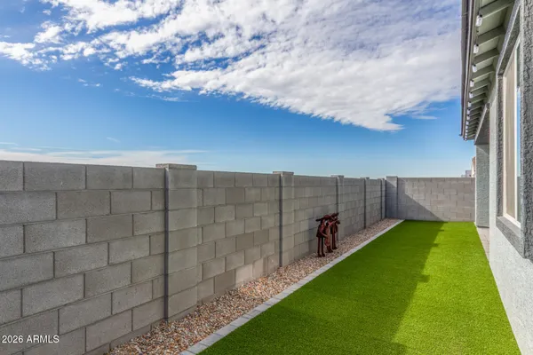 a view of a yard with wooden fence