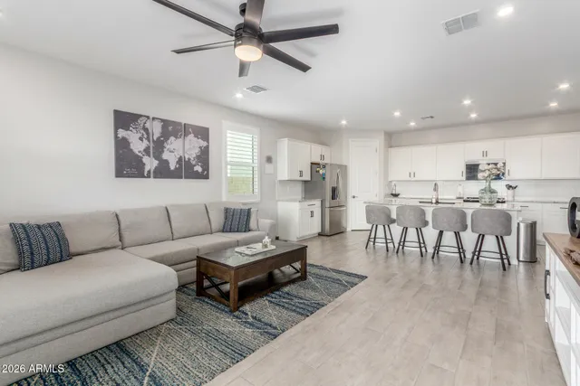 a living room with furniture and kitchen view