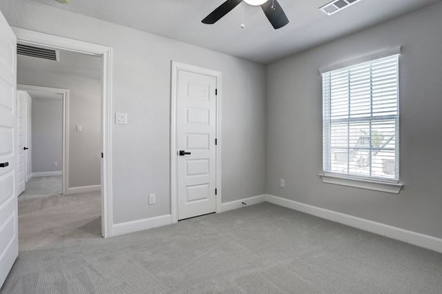 17309 Howdy Way Manor, TX 78653 - Photo 10 of 12 an empty room with chandelier fan