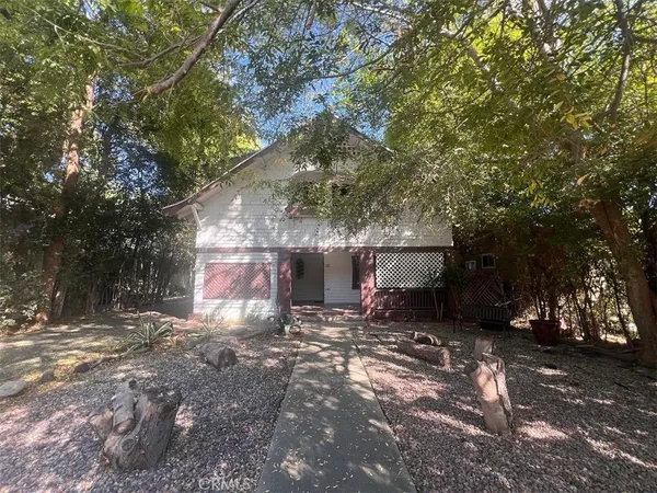 a view of a house with a yard and tree