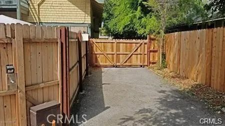 a view of a backyard with wooden fence