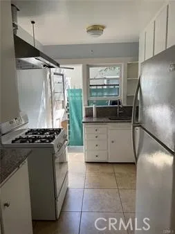 a kitchen with granite countertop a refrigerator and a stove