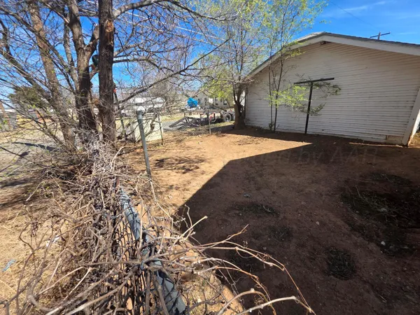 a backyard of a house with a tree