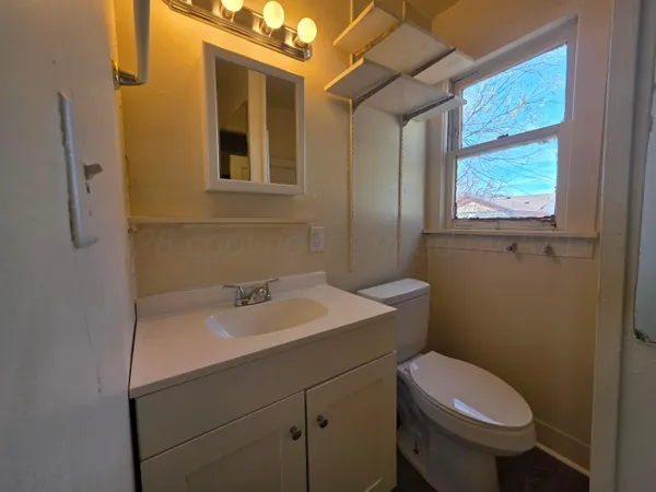 a bathroom with a sink toilet and mirror