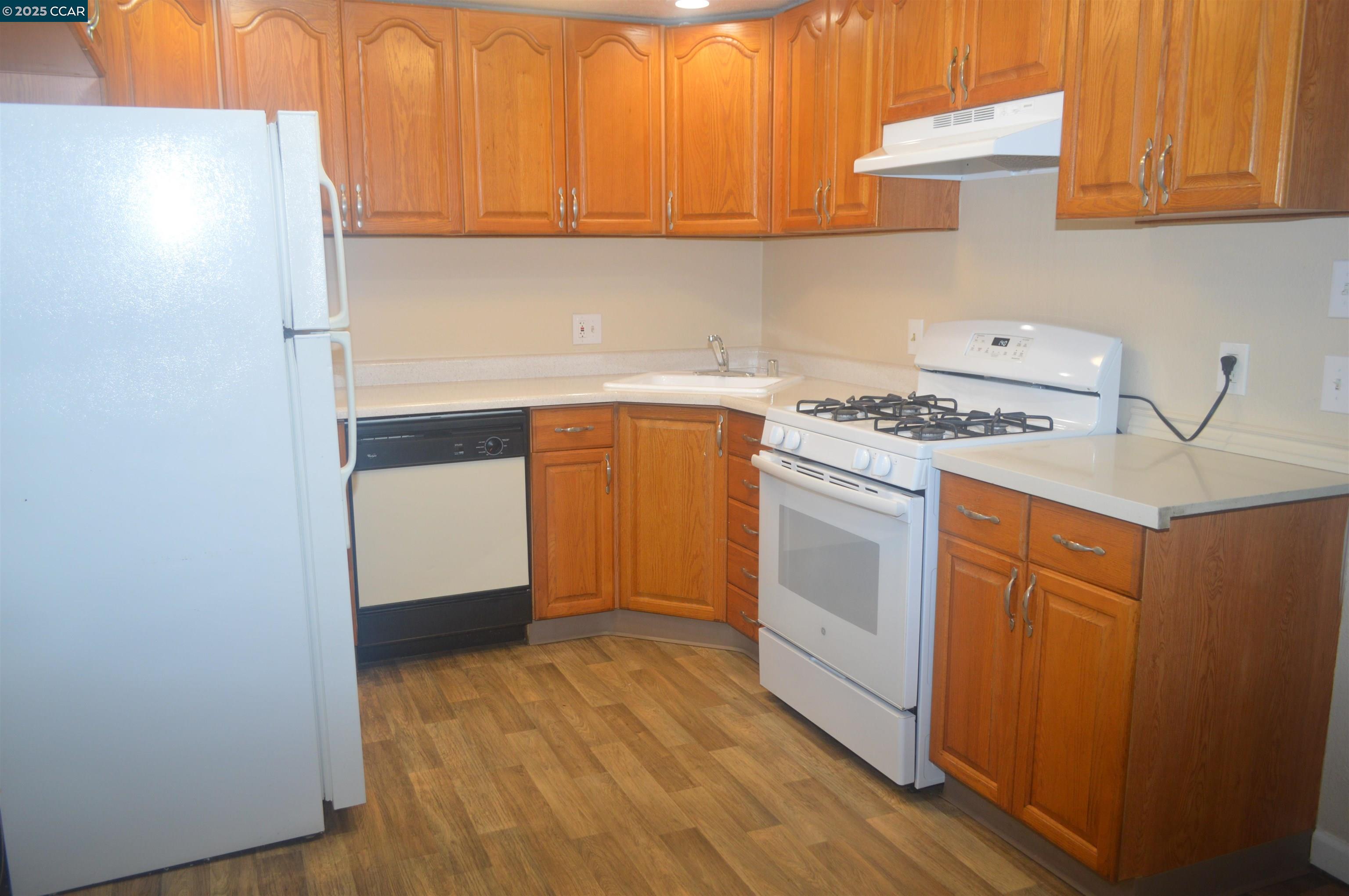 92 Beach Drive Bay Point, CA 94565 - Photo 6 of 19 a kitchen with white cabinets and white appliances