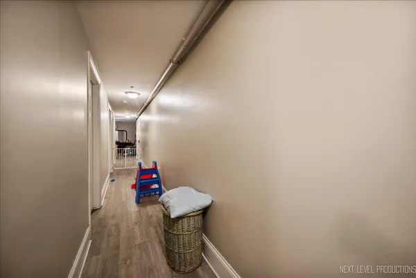 a hallway with table and a mirror