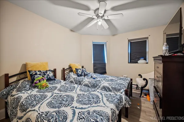 a bedroom with a bed and wooden floor