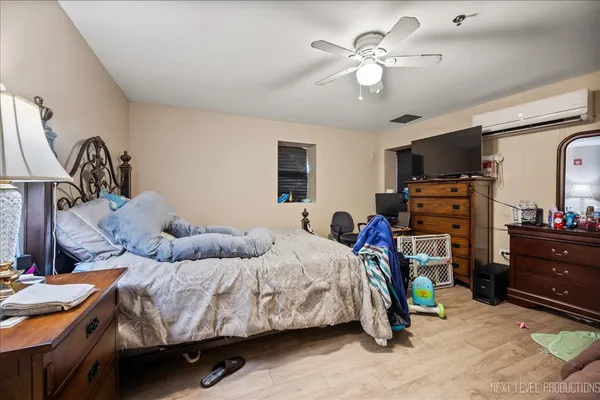 a bedroom with bed and a chandelier