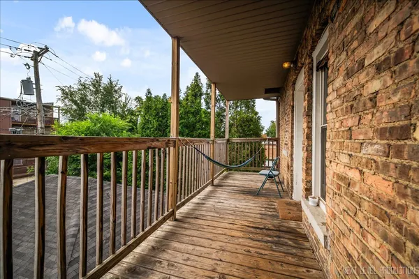 a view of a balcony with wooden floor