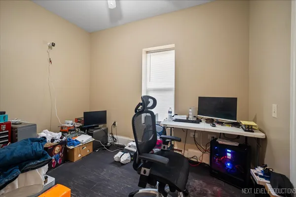 a view of a workspace with furniture and a window