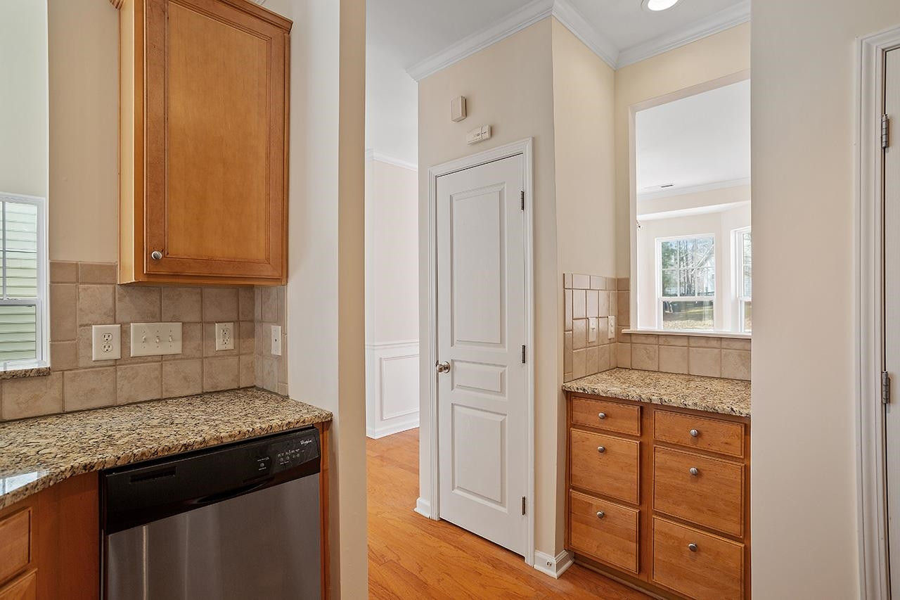 3317 Silver Star Drive Durham, NC 27713 - Photo 12 of 25 a kitchen with granite countertop cabinets and window