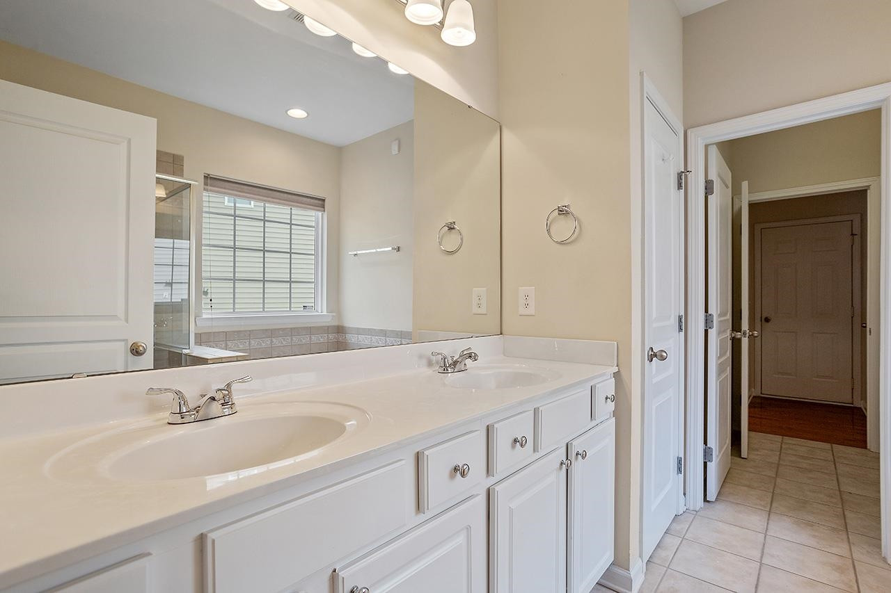 3317 Silver Star Drive Durham, NC 27713 - Photo 15 of 25 a bathroom with a sink double vanity and a mirror