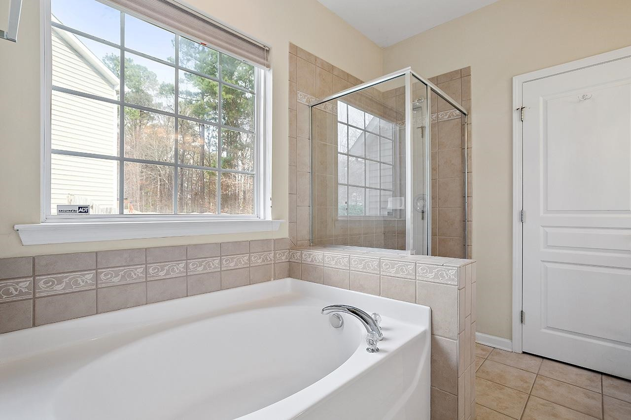 3317 Silver Star Drive Durham, NC 27713 - Photo 16 of 25 a white bath tub sitting next to a window