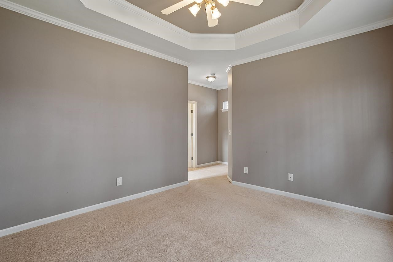 3317 Silver Star Drive Durham, NC 27713 - Photo 17 of 25 an empty room with a chandelier fan and a chandelier fan
