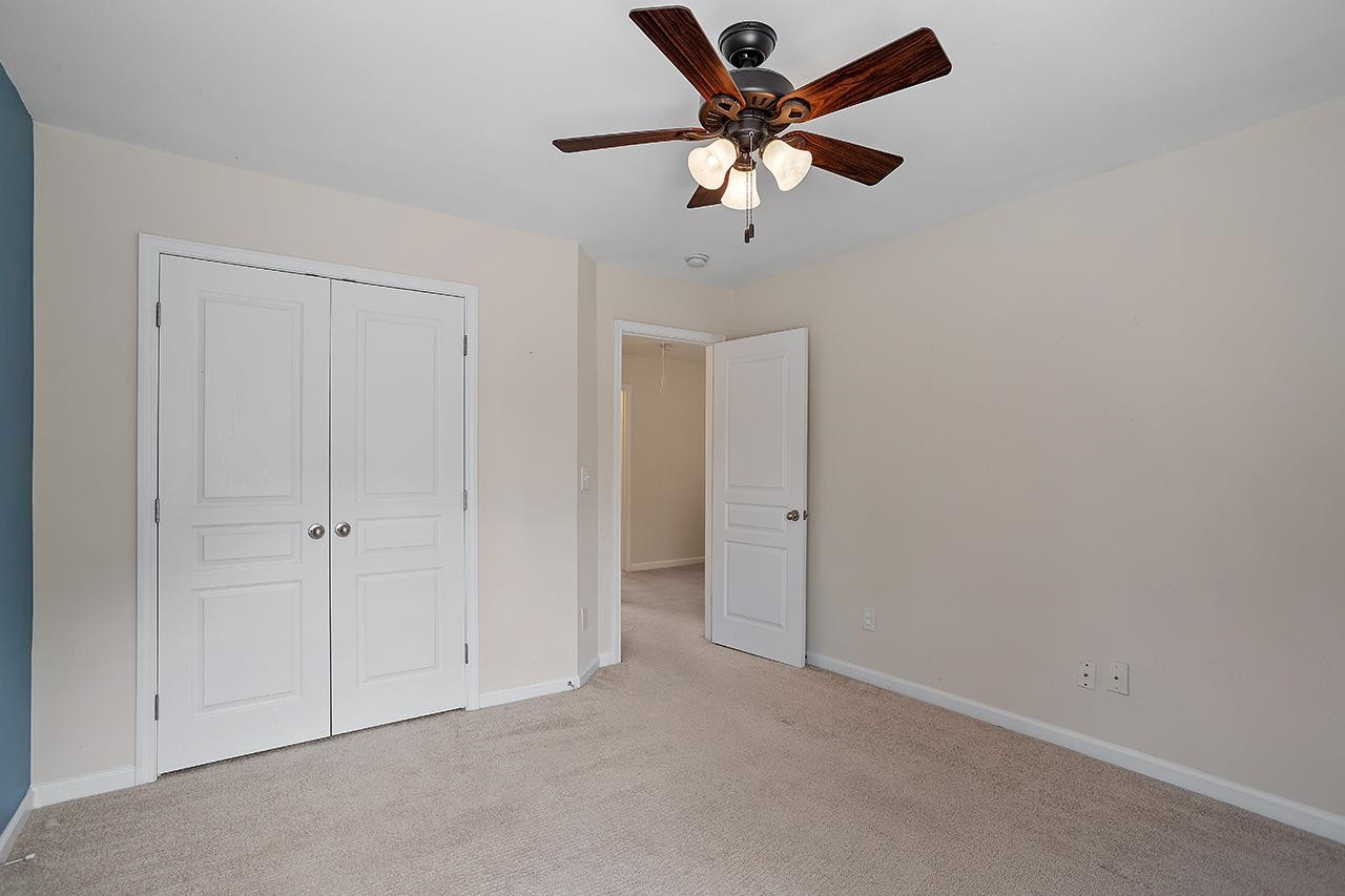 3317 Silver Star Drive Durham, NC 27713 - Photo 19 of 25 an empty room with a ceiling fan and a window