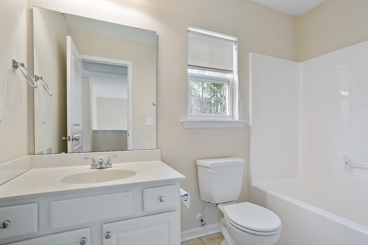 3317 Silver Star Drive Durham, NC 27713 - Photo 20 of 25 a bathroom with a sink a toilet and shower