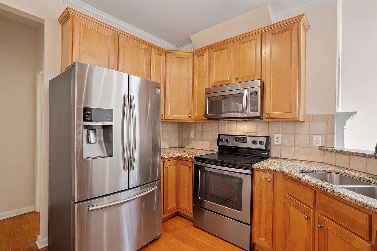 3317 Silver Star Drive Durham, NC 27713 - Photo 10 of 25 a kitchen with stainless steel appliances granite countertop a refrigerator stove and microwave