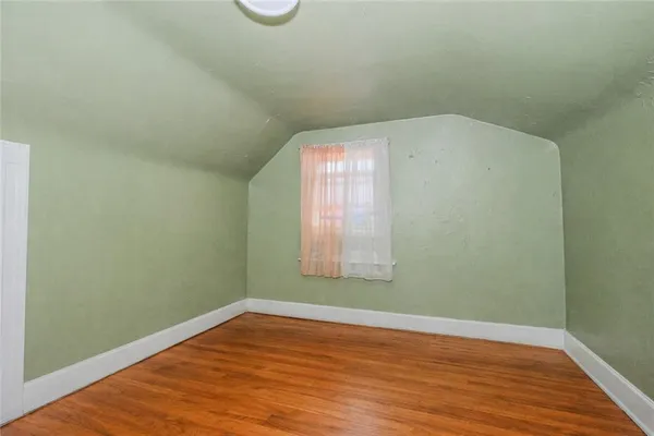 a view of a room with a refrigerator and window