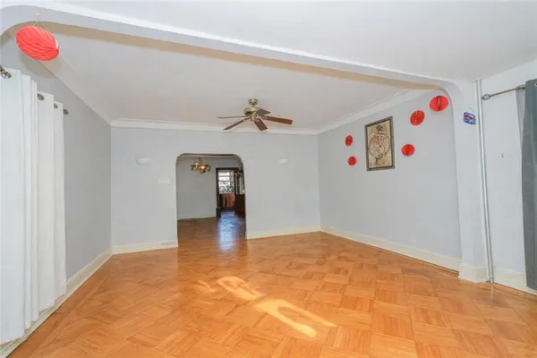 a bedroom with a bed and a chandelier fan