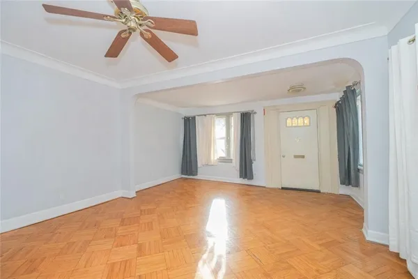 a view of an entryway with wooden floor