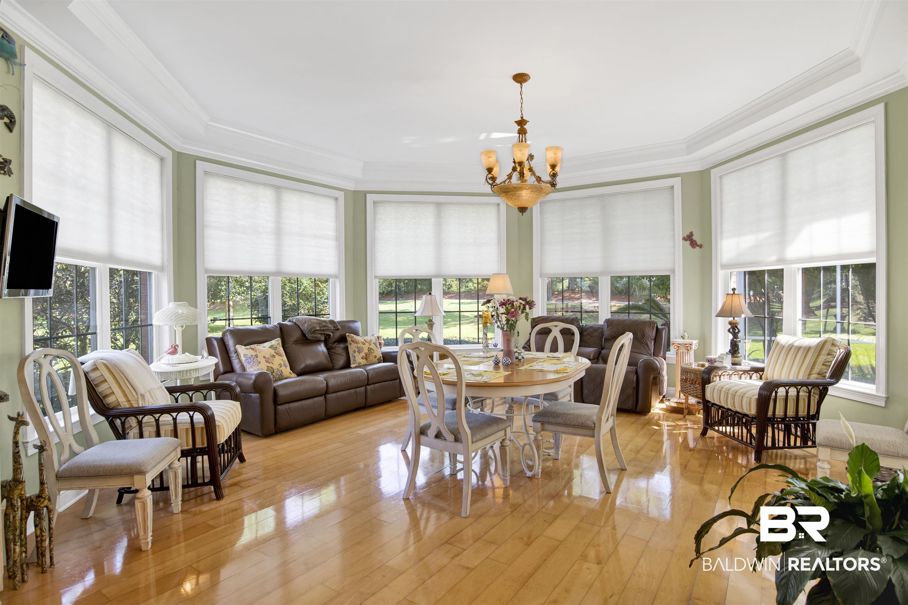 23014 Carnoustie Drive Foley, AL 36535 - Photo 27 of 49 Sunroom / solarium with ornamental molding, a chandelier, and wood-type flooring