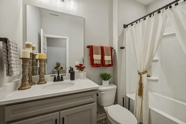 a large kitchen with stainless steel appliances kitchen island granite countertop a stove top oven a sink dishwasher a dining table and chairs with wooden floor