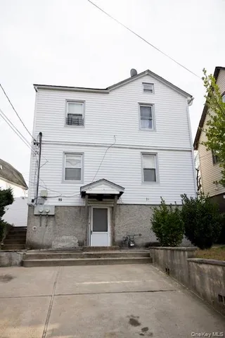 a view of a white house with large windows