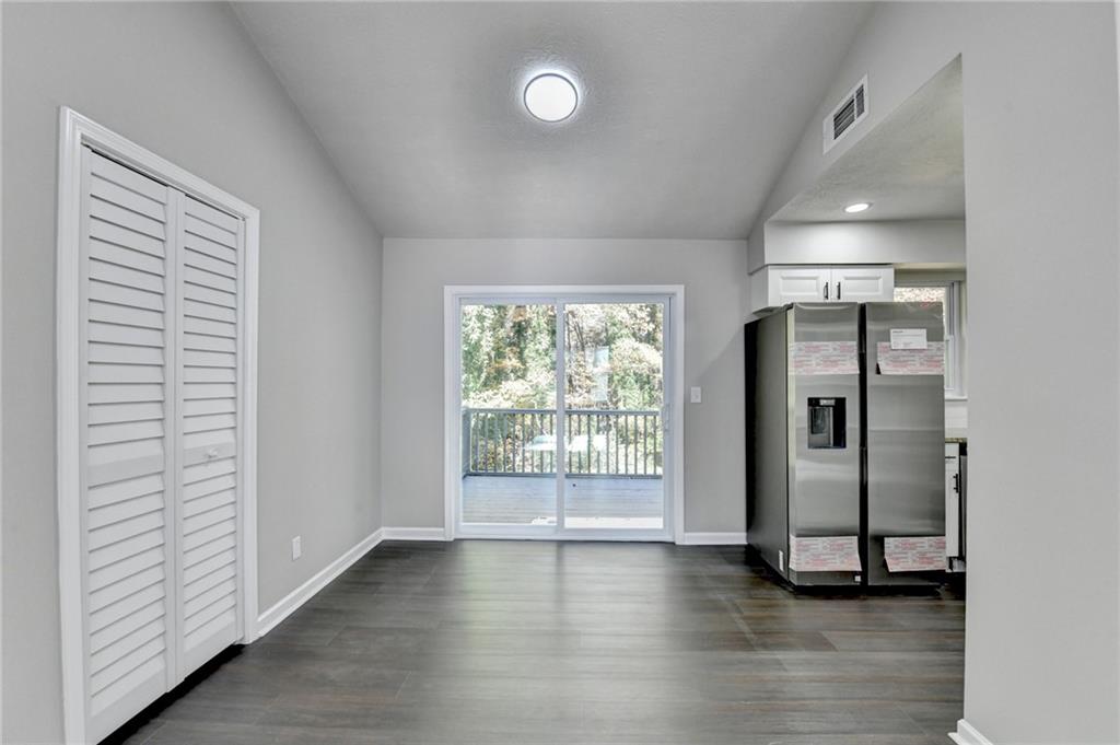 2853 Franklin Road Southwest Lawrenceville, GA 30044 - Photo 12 of 40 an empty room with wooden floor and windows