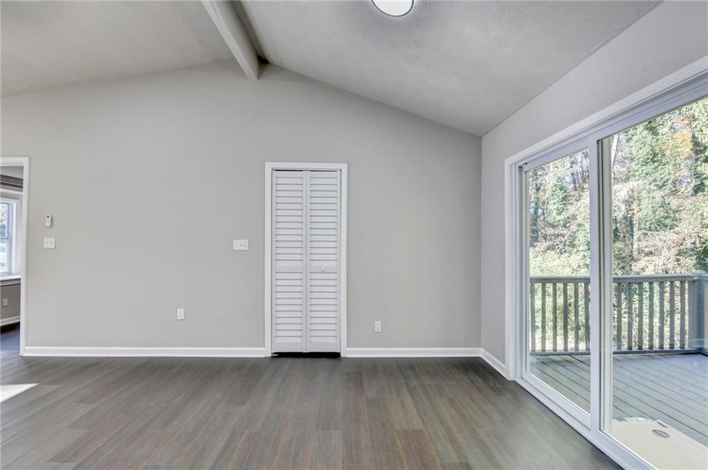 2853 Franklin Road Southwest Lawrenceville, GA 30044 - Photo 13 of 40 an empty room with wooden floor and windows