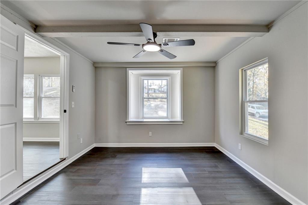 2853 Franklin Road Southwest Lawrenceville, GA 30044 - Photo 19 of 40 a view of an empty room with wooden floor and a window
