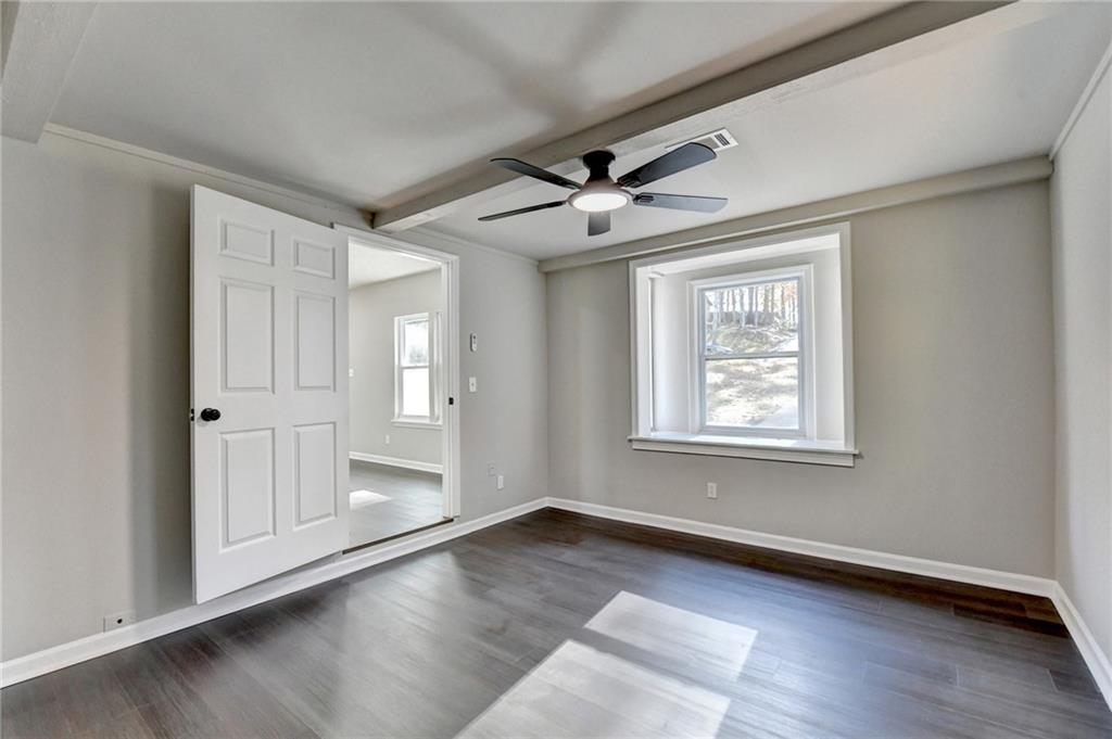 2853 Franklin Road Southwest Lawrenceville, GA 30044 - Photo 20 of 40 a view of an empty room with a window and wooden floor