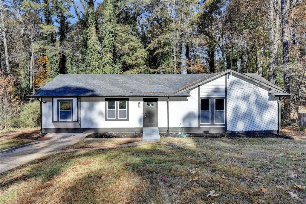 2853 Franklin Road Southwest Lawrenceville, GA 30044 - Photo 2 of 40 a house with lots of trees in the background