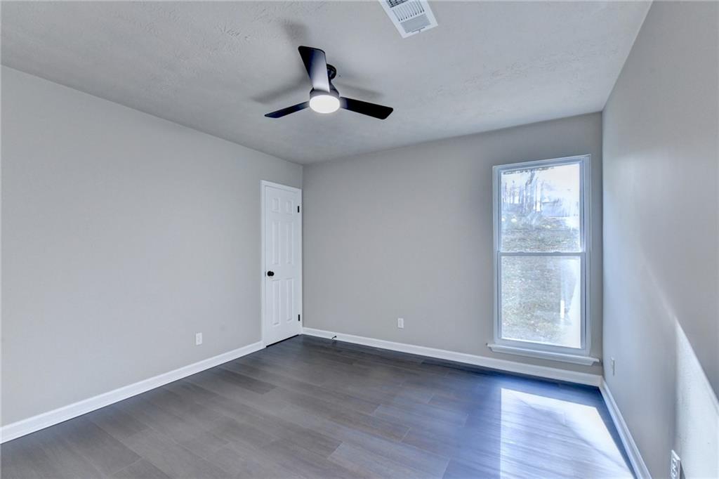 2853 Franklin Road Southwest Lawrenceville, GA 30044 - Photo 23 of 40 wooden floor in an empty room with a window