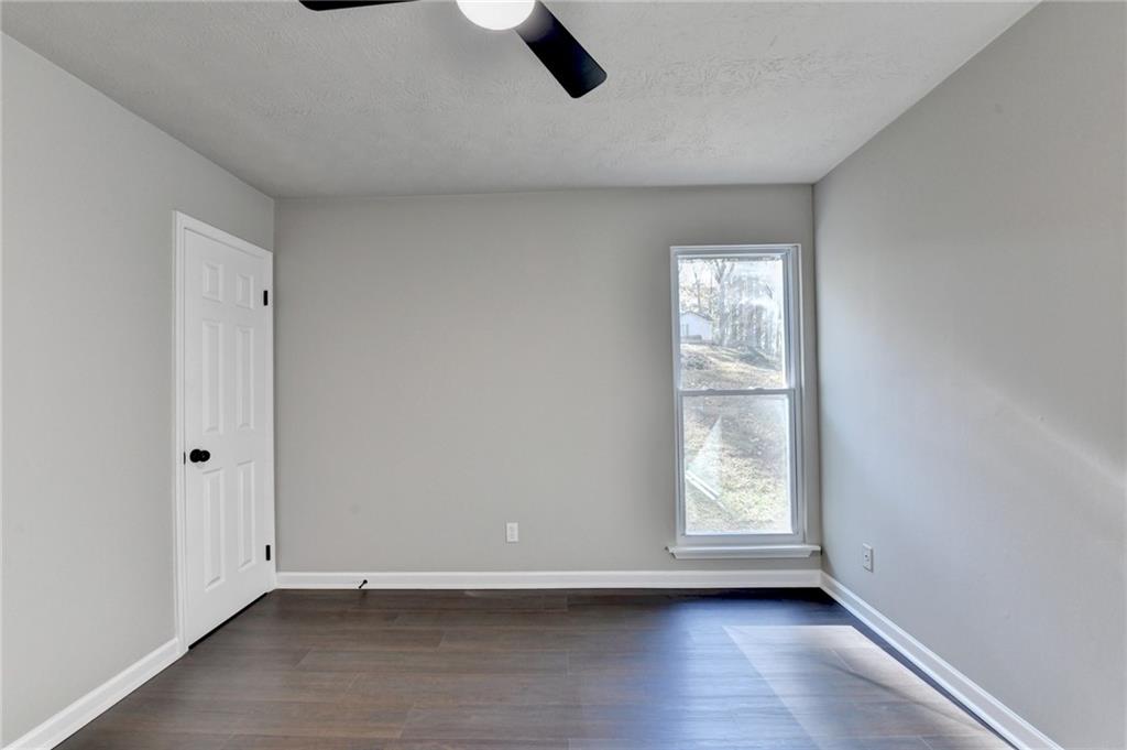 2853 Franklin Road Southwest Lawrenceville, GA 30044 - Photo 24 of 40 a view of an empty room with wooden floor and a window
