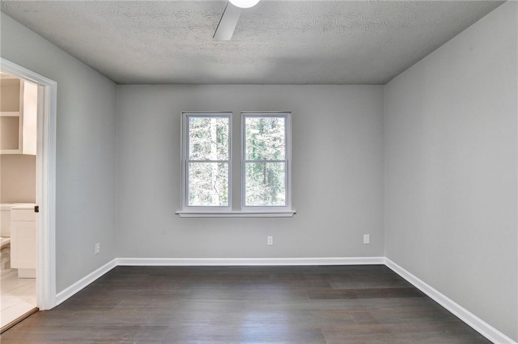 2853 Franklin Road Southwest Lawrenceville, GA 30044 - Photo 26 of 40 an empty room with wooden floor and windows