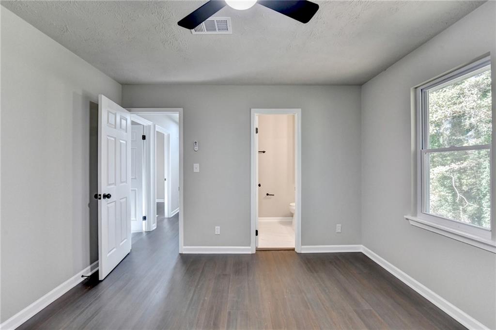 2853 Franklin Road Southwest Lawrenceville, GA 30044 - Photo 27 of 40 an empty room with wooden floor and windows