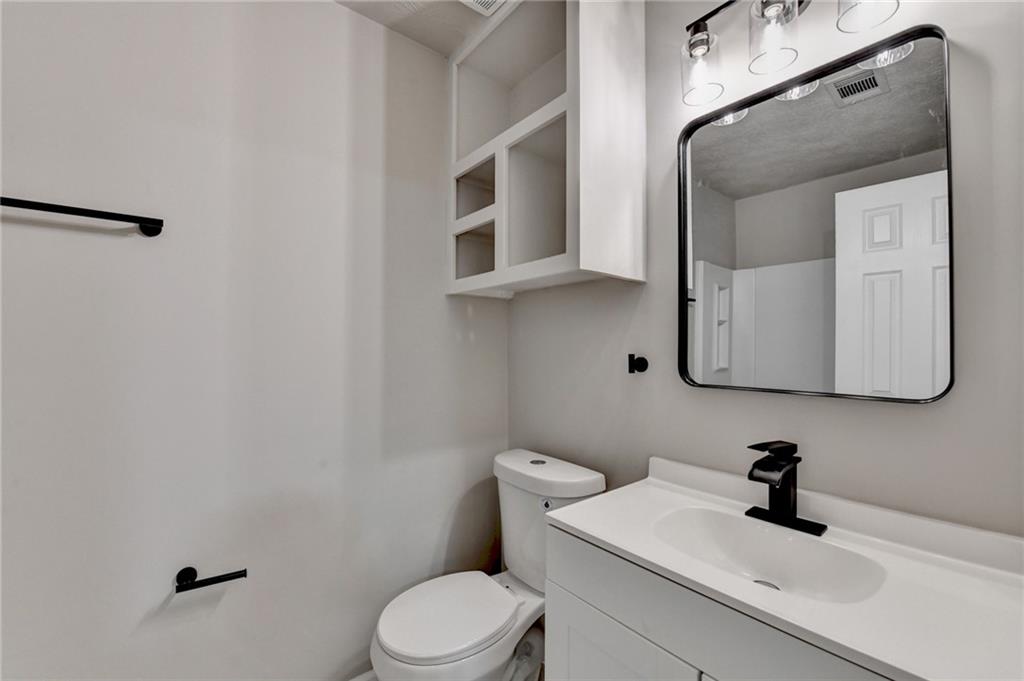 2853 Franklin Road Southwest Lawrenceville, GA 30044 - Photo 29 of 40 a bathroom with a toilet sink and mirror