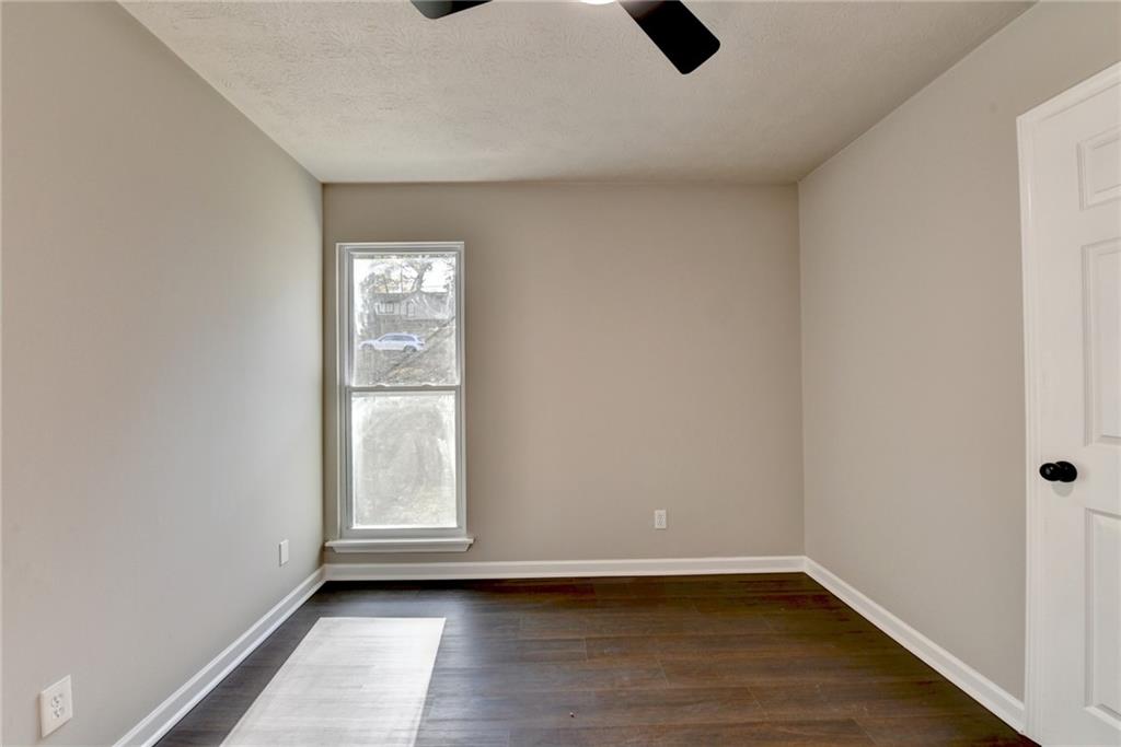 2853 Franklin Road Southwest Lawrenceville, GA 30044 - Photo 31 of 40 a view of an empty room with wooden floor and a window