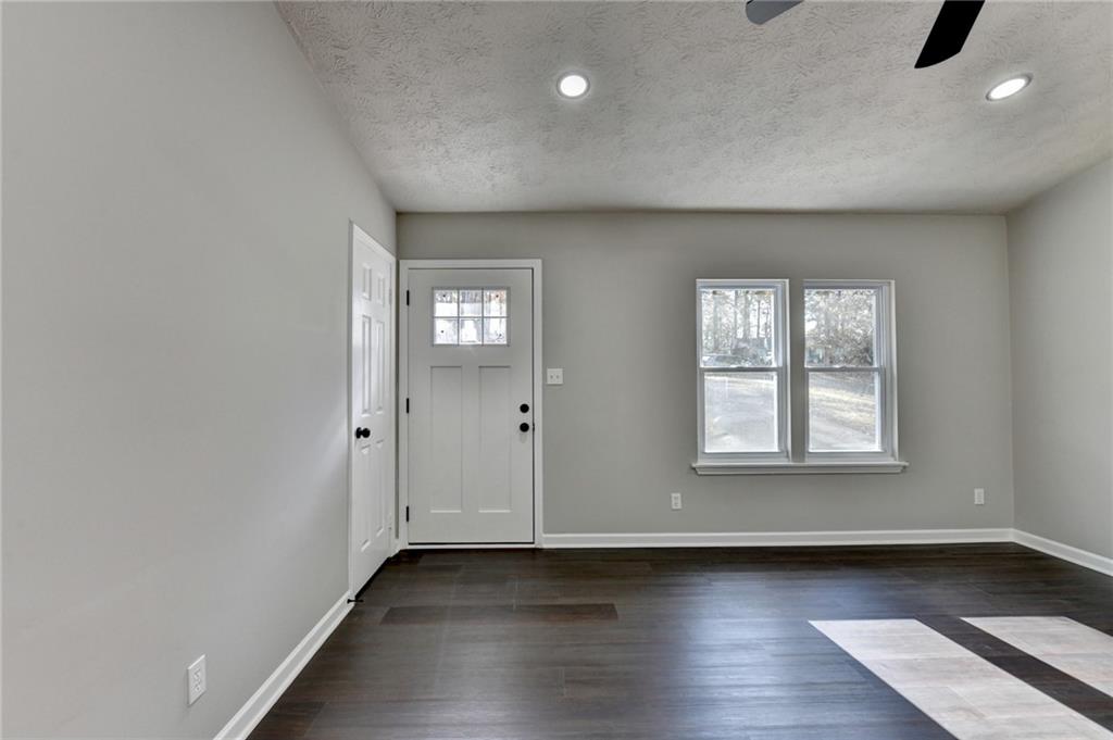 2853 Franklin Road Southwest Lawrenceville, GA 30044 - Photo 6 of 40 an empty room with wooden floor and windows