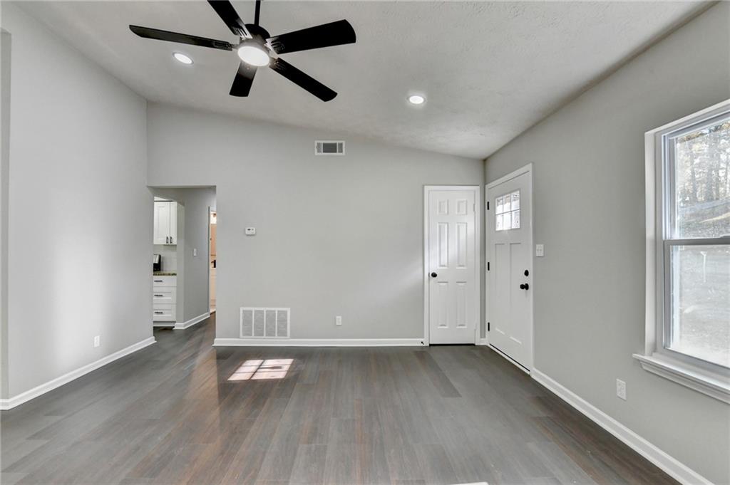 2853 Franklin Road Southwest Lawrenceville, GA 30044 - Photo 8 of 40 an empty room with wooden floor and windows