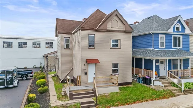 a front view of a house with garden