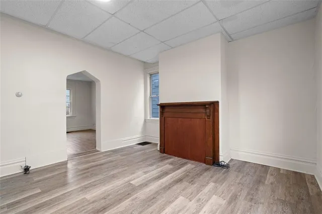 an empty room with wooden floor and closet