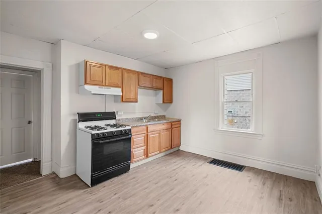 a kitchen with stainless steel appliances granite countertop a stove and a refrigerator