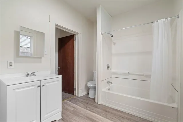 a bathroom with a bathtub a sink a toilet and a mirror