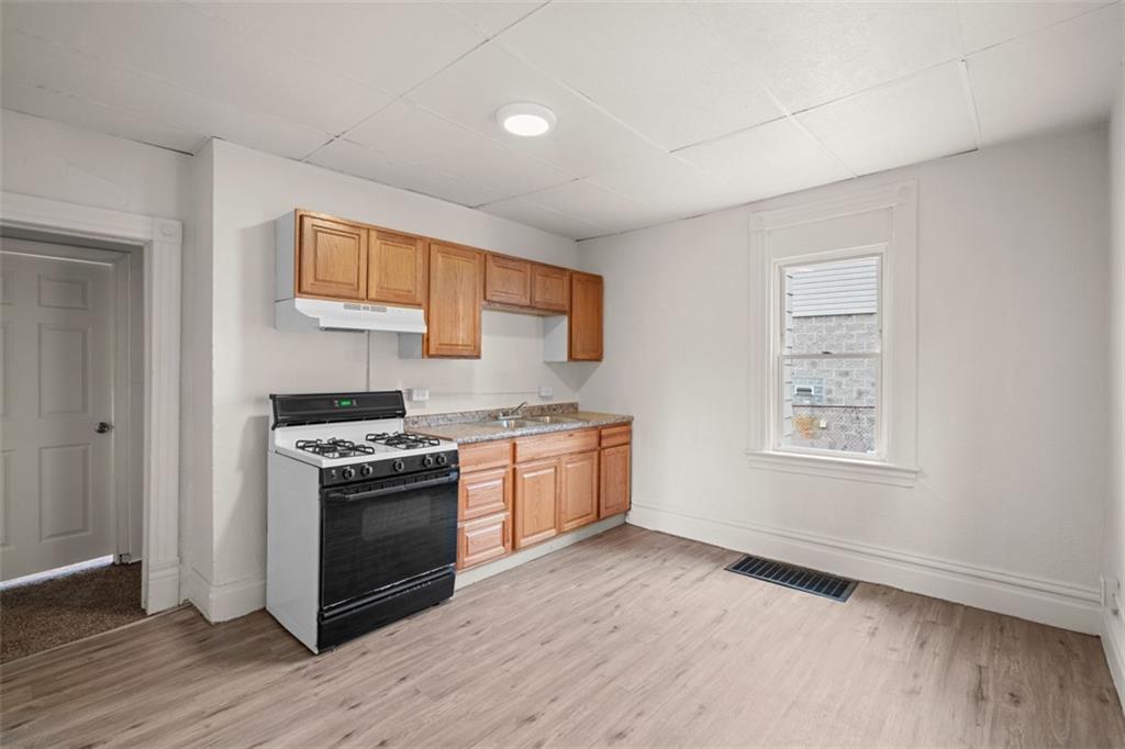 405 Main Street Coraopolis, PA 15108 - Photo 6 of 24 a kitchen with stainless steel appliances granite countertop a stove and a refrigerator