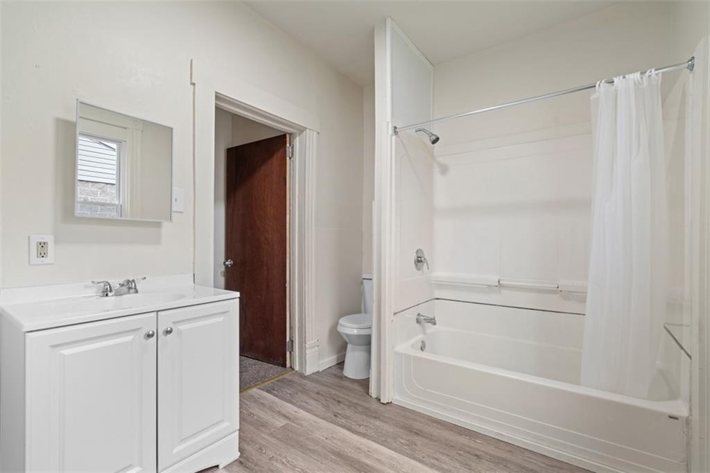 405 Main Street Coraopolis, PA 15108 - Photo 10 of 24 a bathroom with a bathtub a sink a toilet and a mirror