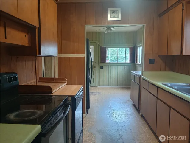 a kitchen with kitchen island a sink stove and cabinets