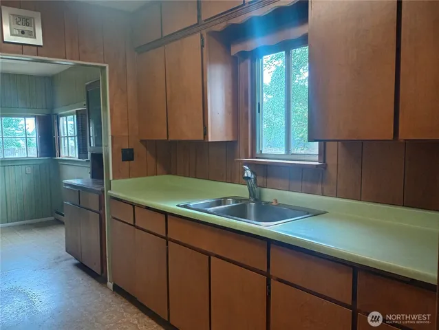 a kitchen with a sink cabinets and window