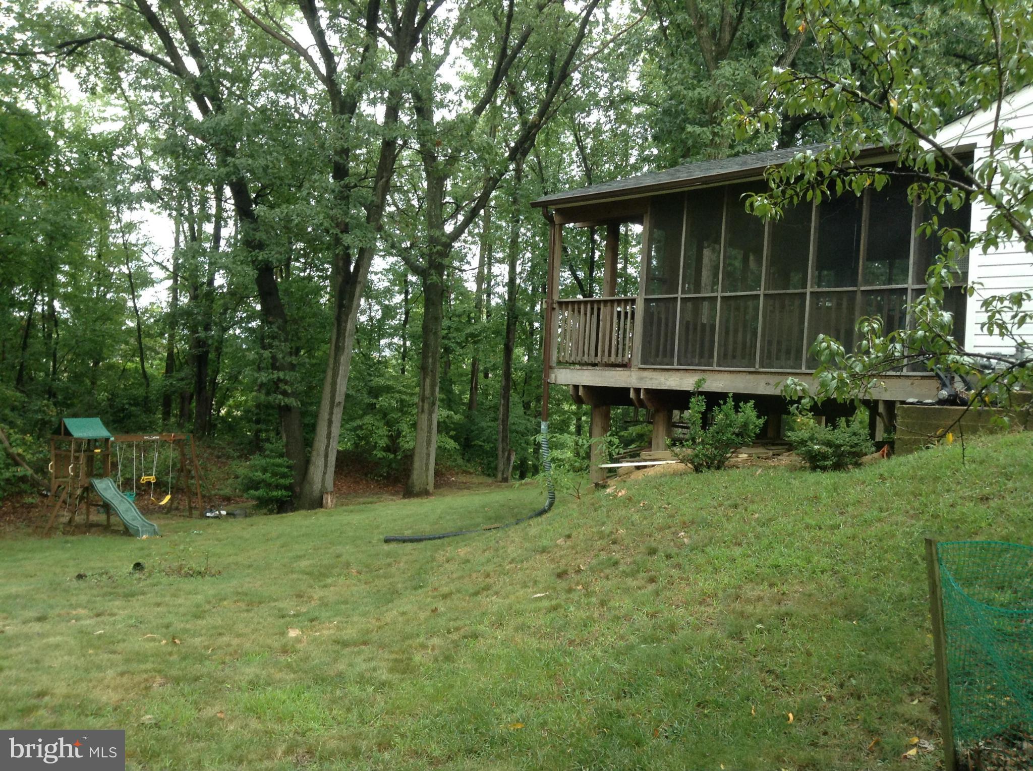6814 Mayo Court Springfield, VA 22150 - Photo 11 of 30 a backyard of a house with plants and wooden fence