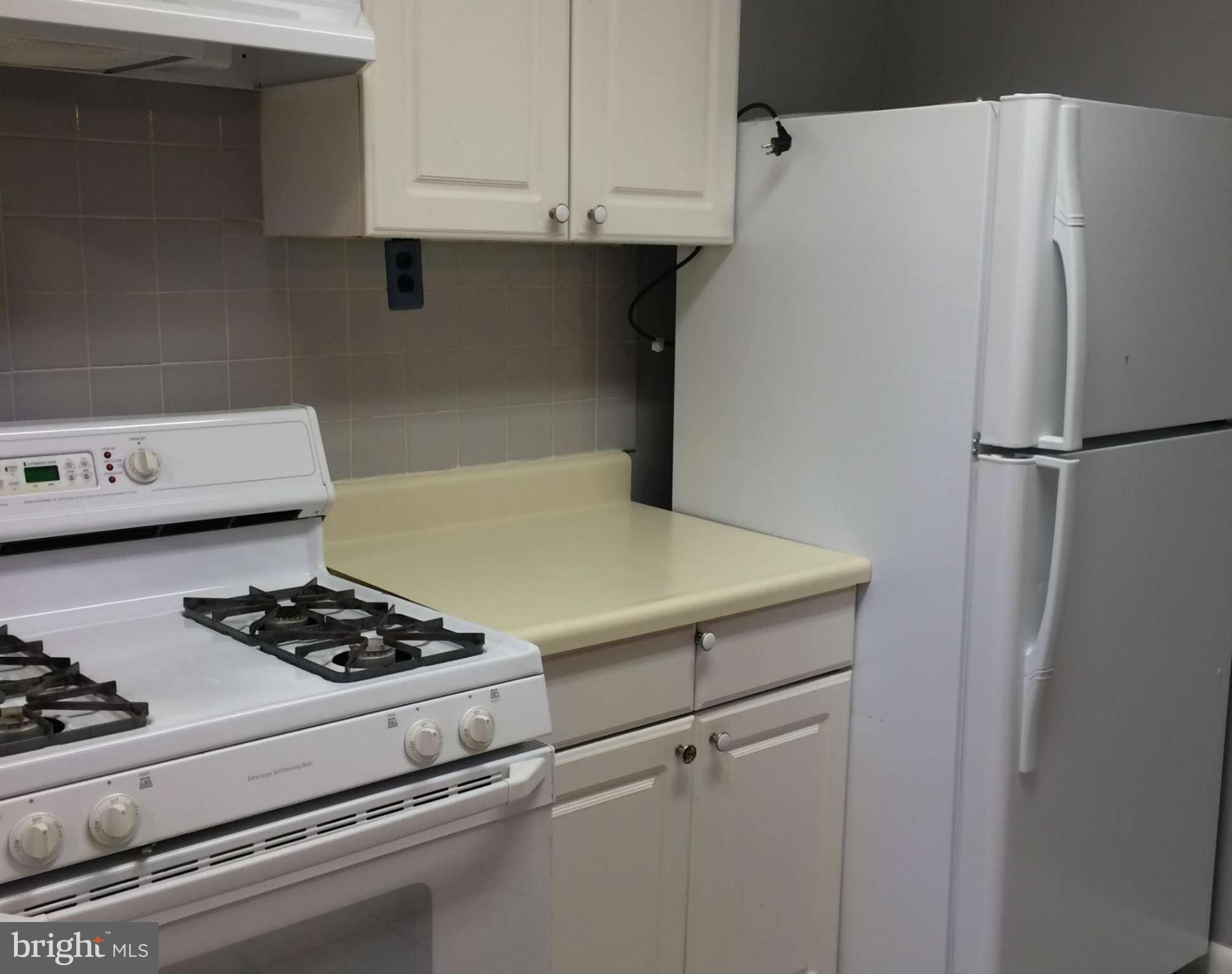 6814 Mayo Court Springfield, VA 22150 - Photo 18 of 30 a white refrigerator freezer and a stove sitting inside of a kitchen